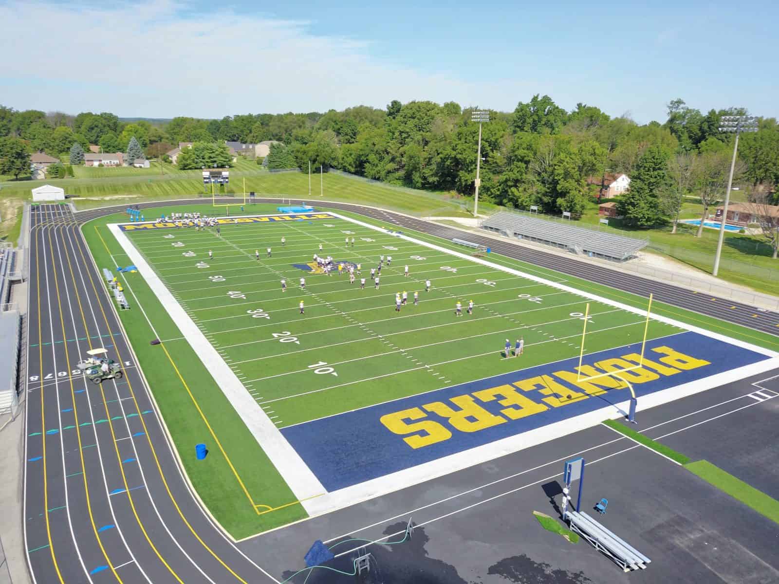 football field with players on it and track around it in Indiana