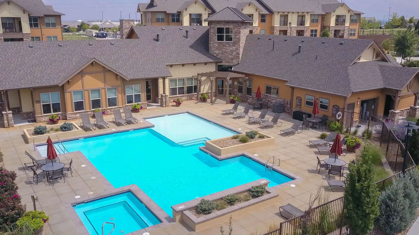 drone photo of apartment complex with swimming pool in foreground