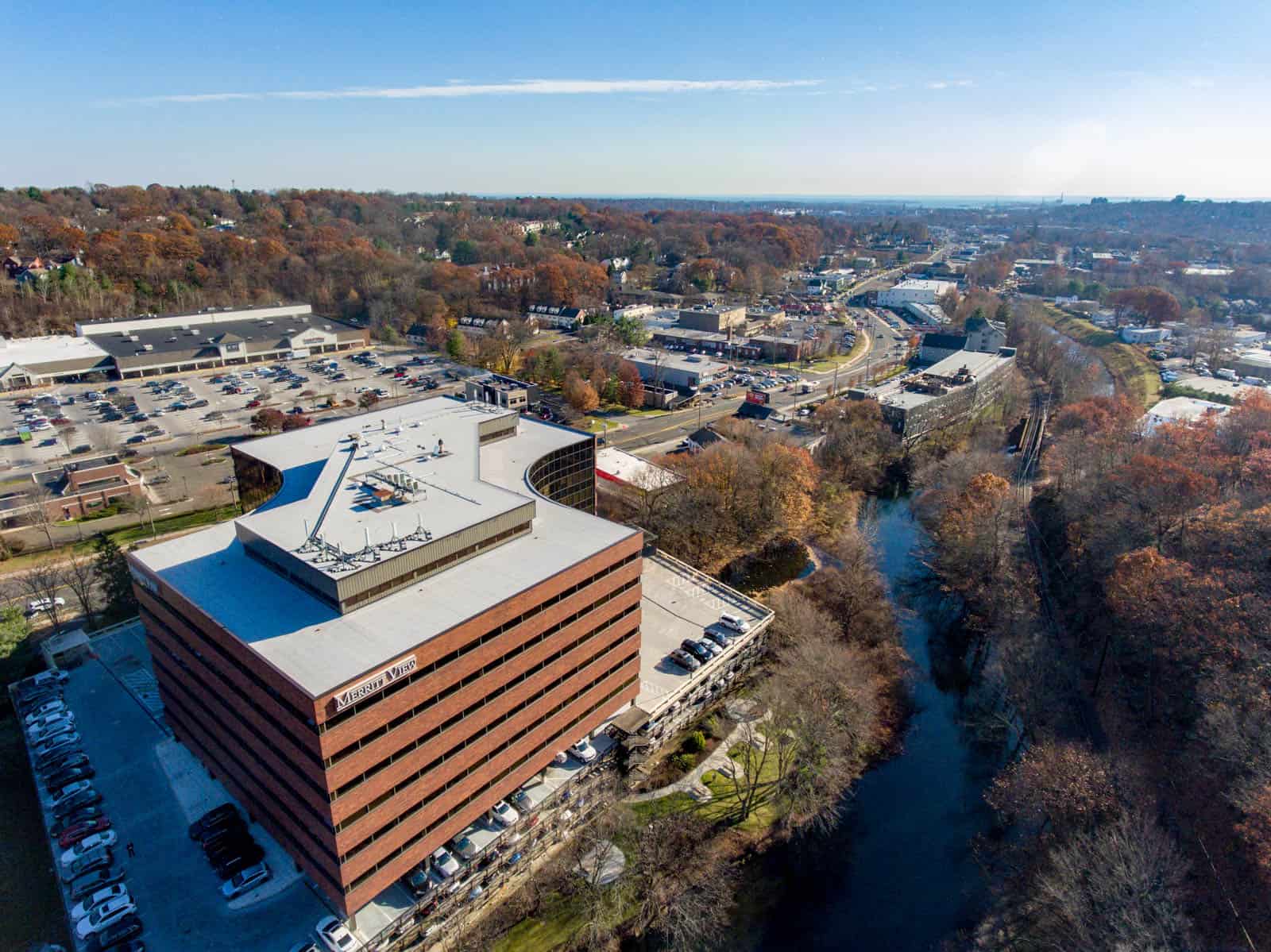 drone photo of brick and glass office building in Connecticut