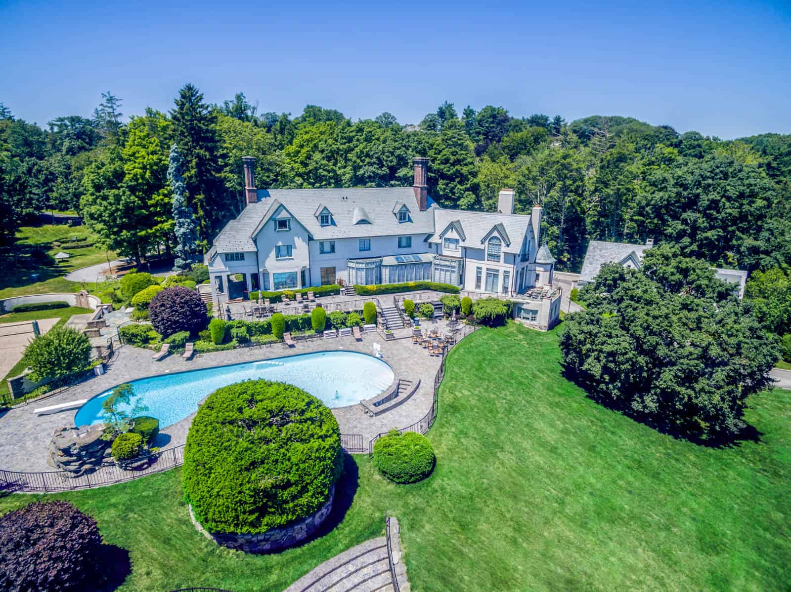 drone photo of mansion with swimming pool in Greenwich, CT