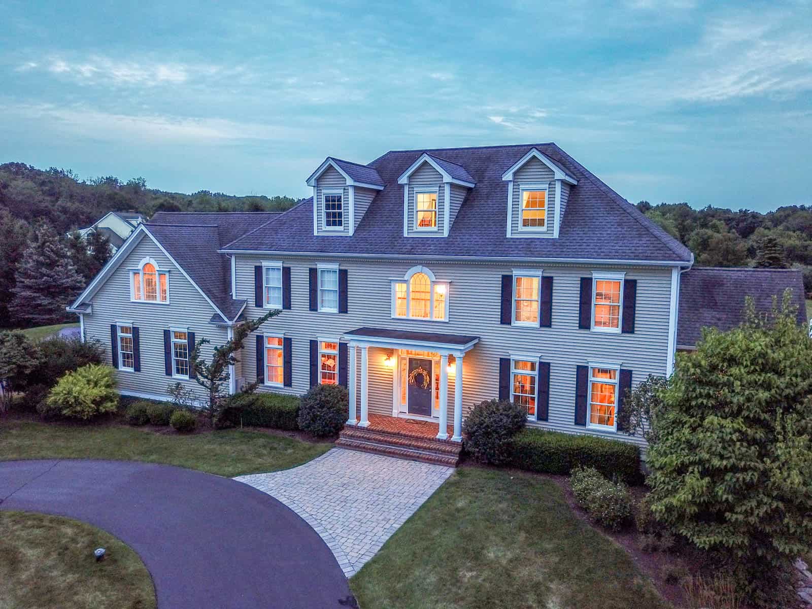 aerial drone photo of front of house in Guilford, CT taken at dusk