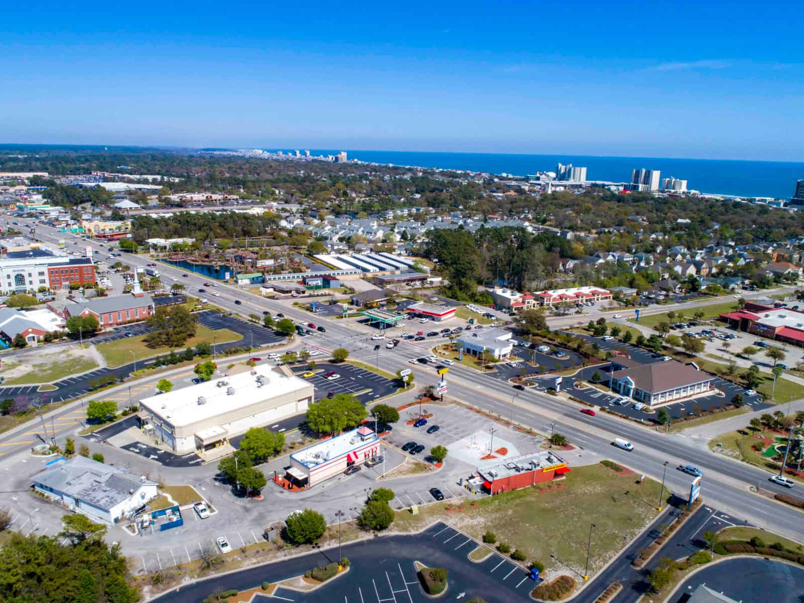aerial drone photo above shopping plaza and commercial real estate properties in South Carolina