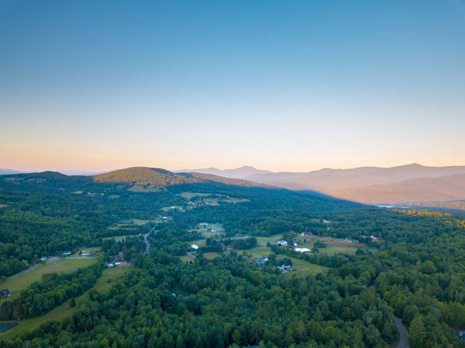 Stowe, Vermont aerial drone photo of landscape with mountains and houses