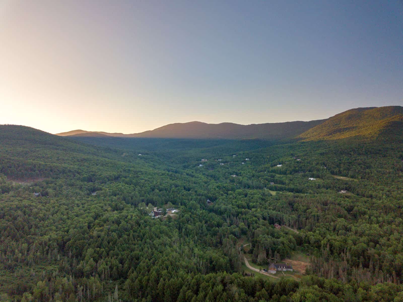 drone photo of mountains catching morning sun rays in Stowe, VT