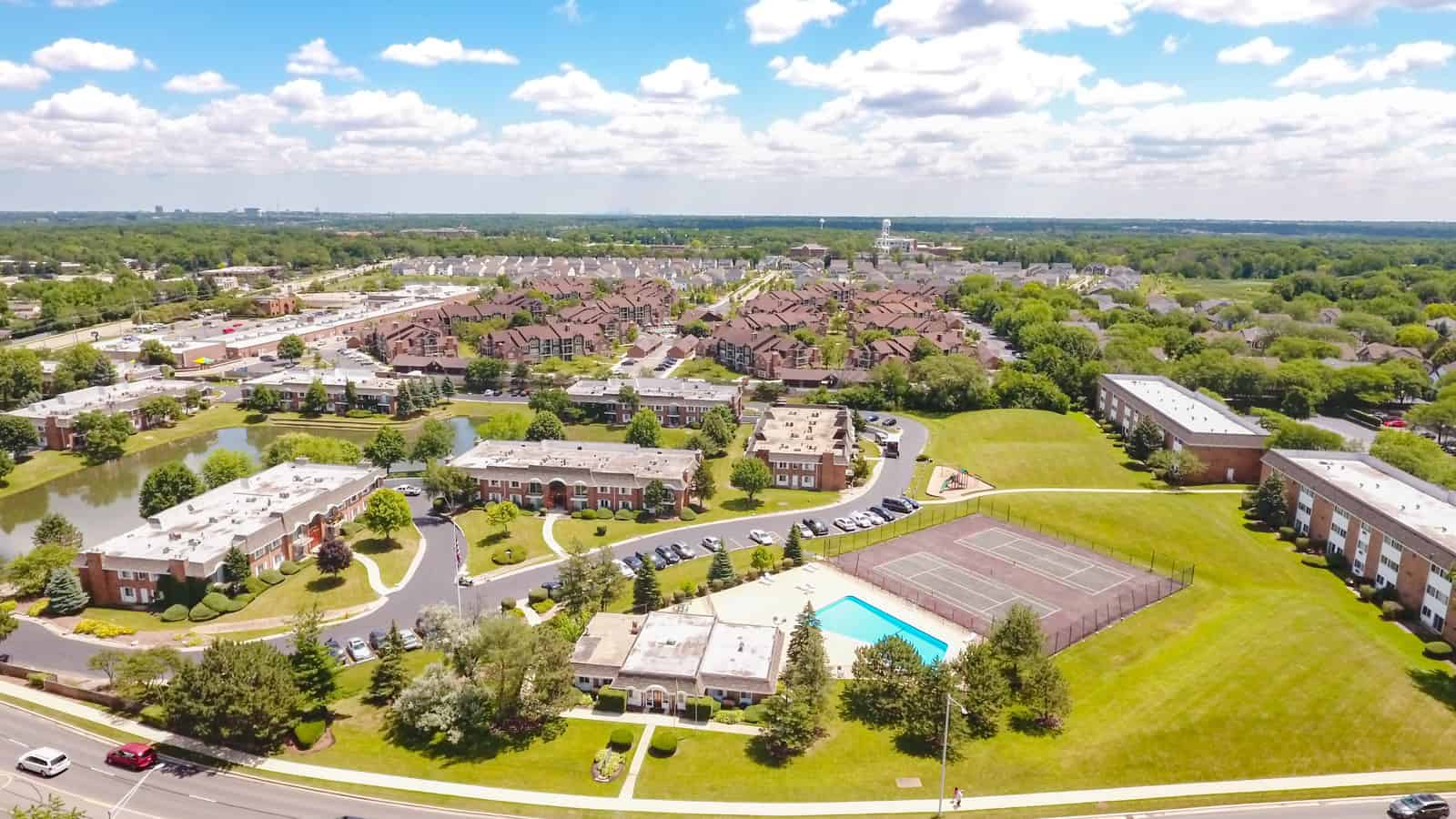 apartment complex aerial drone photo with swimming pool and two tennis courts in Illinois