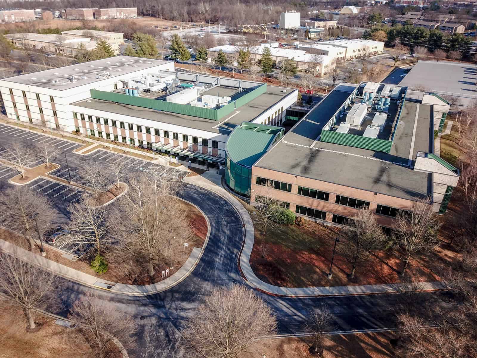 aerial photo of office building with empty parking lot