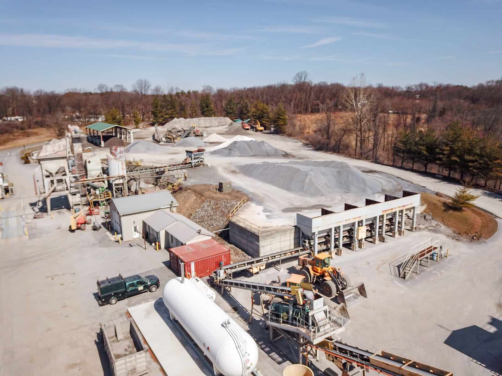 construction site in Maryland with trucks, conveyor belts, and mounds of sand