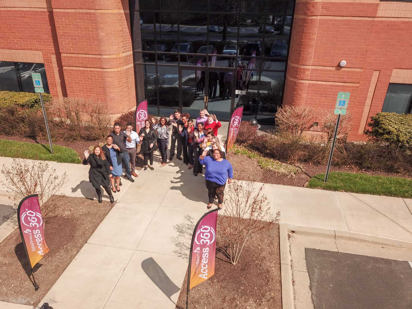 employees standing in front of office building for event drone photo