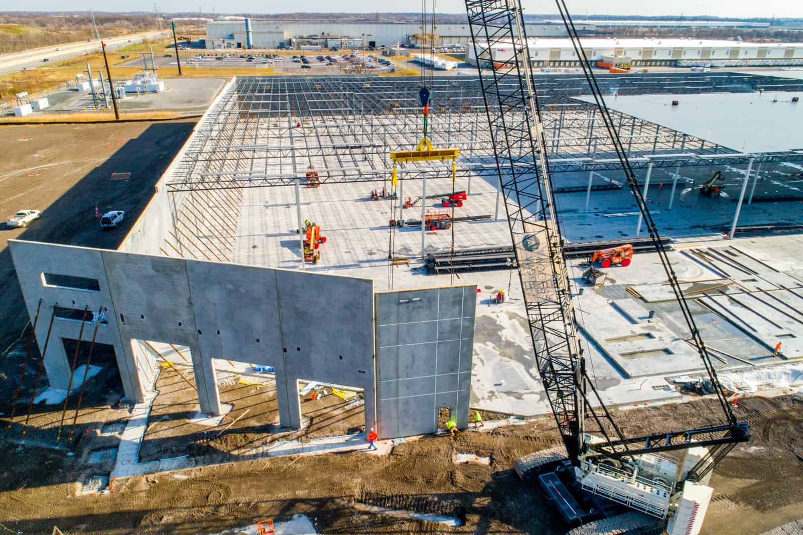 crane lifting cement wall in place for new building being constructed in Maryland
