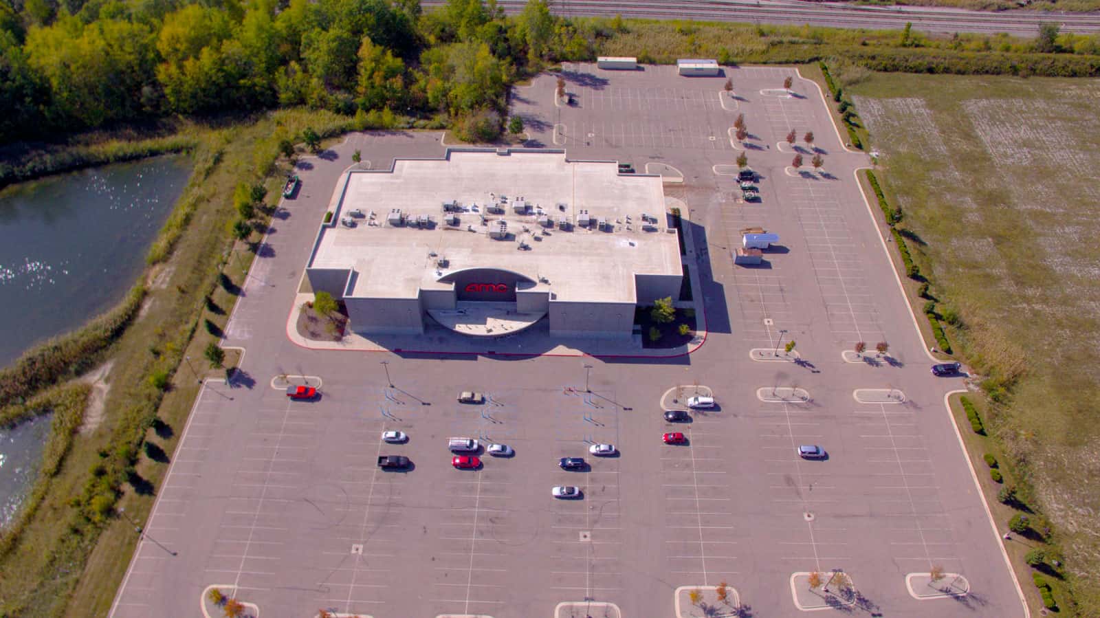 drone photo of AMC movie theater in Michigan with empty parking lot