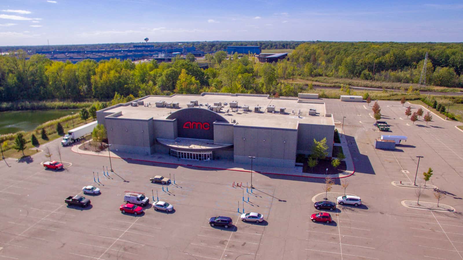 AMC movie theater with empty parking lot drone photo taken in Michigan