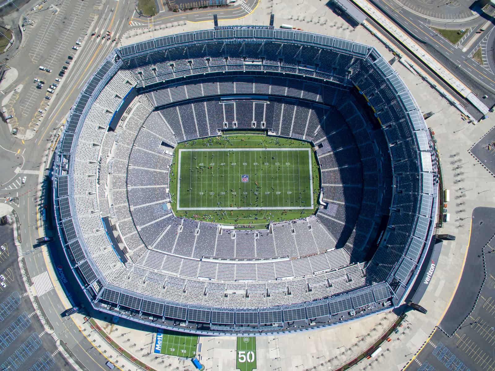 Looking down at football field inside MetLife Stadium drone photo