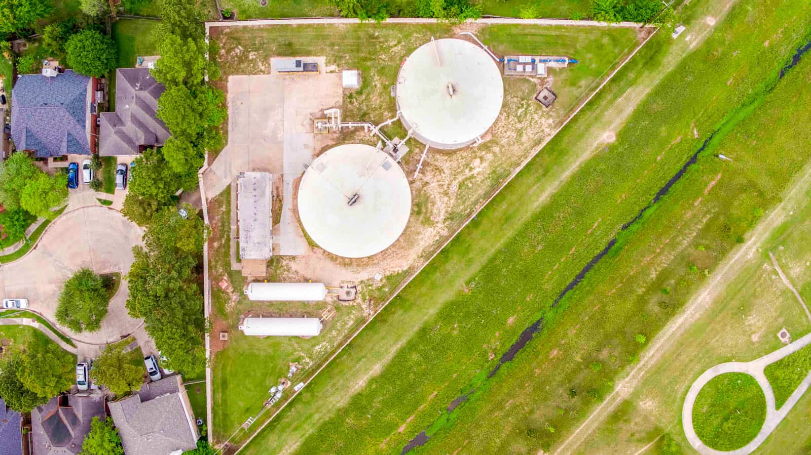 aerial drone photo looking down at two white water tanks