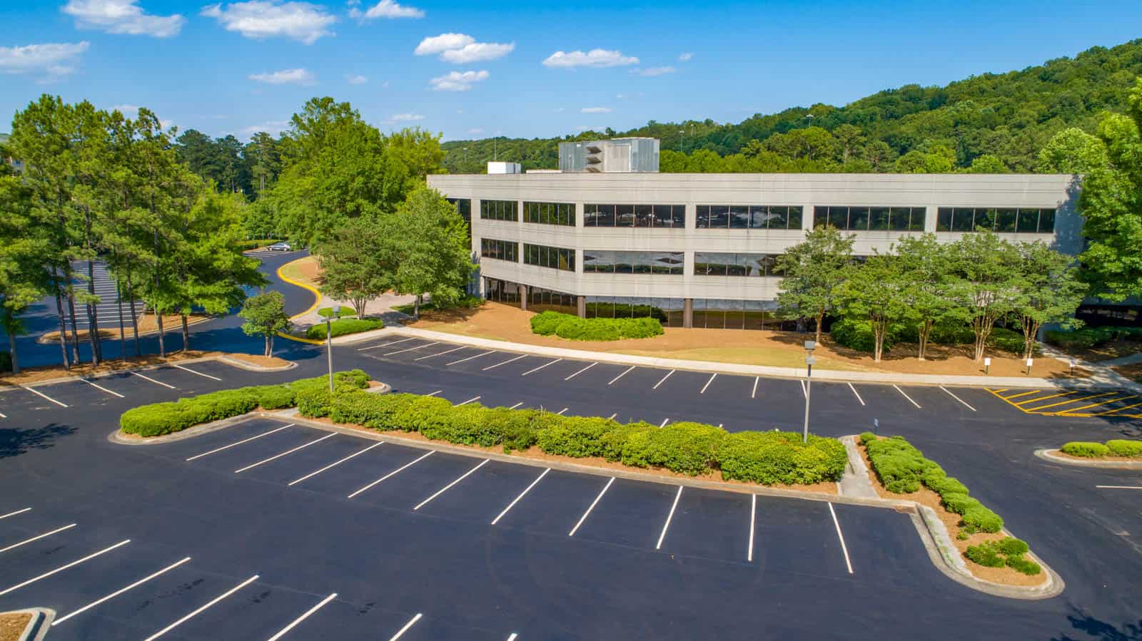 aerial drone photo of commercial real estate property in Gainesville, GA with full building and parking lot in view