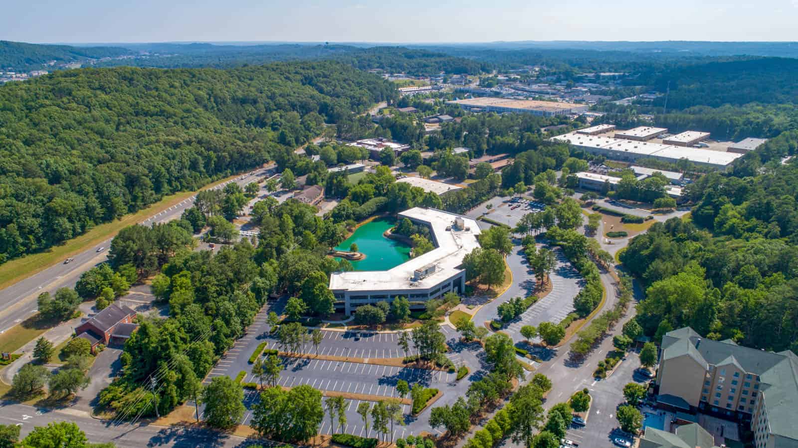 aerial drone photo of side view of office building showing pond in back in Birmingham, Alabama